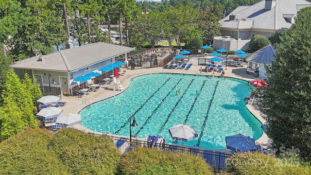 18802 Pentwater Ct, Cornelius, NC 28031 - community pool featuring a patio area and view of wooded area