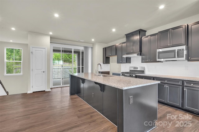 2004 Dornoch Rd, Tega Cay, SC 29708 - kitchen with stainless steel appliances, dark wood-style flooring, an island with sink, healthy amount of natural light, and recessed lighting