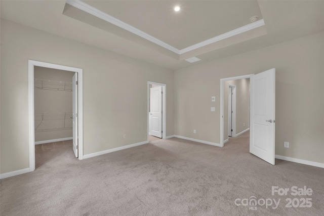 2004 Dornoch Rd, Tega Cay, SC 29708 - unfurnished bedroom featuring a tray ceiling, ornamental molding, a spacious closet, and carpet