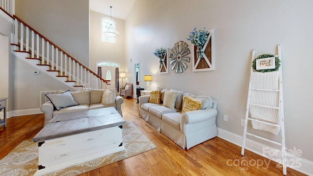 3005 Monterrey Ln, Monroe, NC 28110 - living area with wood finished floors, a towering ceiling, stairway, and arched walkways