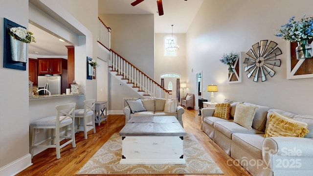 3005 Monterrey Ln, Monroe, NC 28110 - living room with ceiling fan, light wood finished floors, stairway, and a towering ceiling