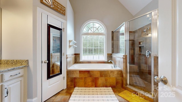 3005 Monterrey Ln, Monroe, NC 28110 - bathroom featuring a garden tub, vanity, a stall shower, lofted ceiling, and tile patterned floors