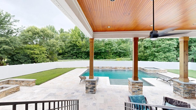 3005 Monterrey Ln, Monroe, NC 28110 - fenced backyard with a patio, a pool with connected hot tub, view of wooded area, and a ceiling fan