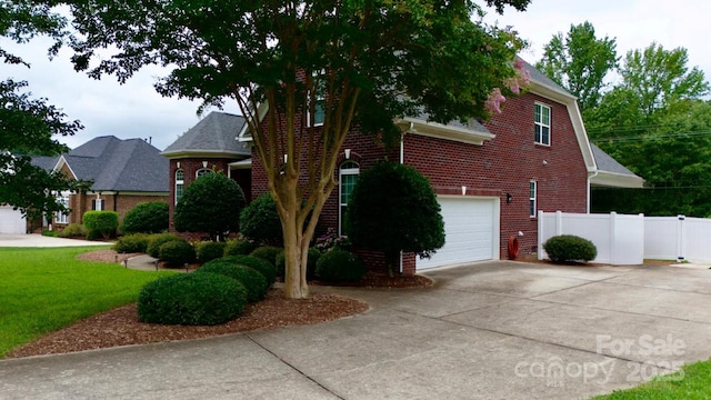 3005 Monterrey Ln, Monroe, NC 28110 - view of side of home featuring brick siding, an attached garage, and concrete driveway