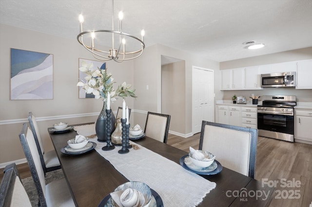 1409 Kensington Rd Unit B-8, Hendersonville, NC 28791 - dining space featuring light wood finished floors and a chandelier