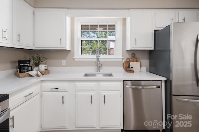 1409 Kensington Rd Unit B-8, Hendersonville, NC 28791 - kitchen with stainless steel appliances, light countertops, and white cabinetry