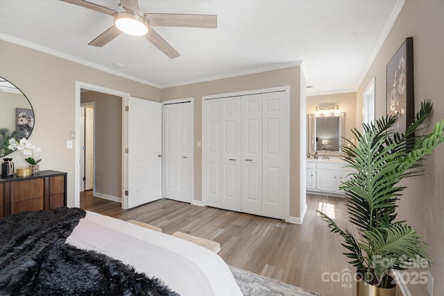 1409 Kensington Rd Unit B-8, Hendersonville, NC 28791 - bedroom with light wood-style flooring, two closets, crown molding, ensuite bath, and ceiling fan