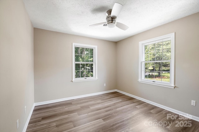 1409 Kensington Rd Unit B-8, Hendersonville, NC 28791 - spare room with wood finished floors, a ceiling fan, and a textured ceiling