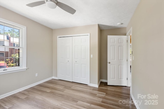 1409 Kensington Rd Unit B-8, Hendersonville, NC 28791 - unfurnished bedroom featuring wood finished floors, a closet, a textured ceiling, and ceiling fan