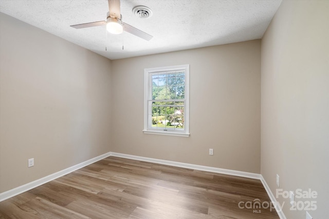 1409 Kensington Rd Unit B-8, Hendersonville, NC 28791 - empty room with wood finished floors, a ceiling fan, and a textured ceiling