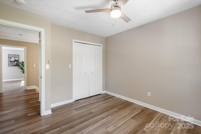 1409 Kensington Rd Unit B-8, Hendersonville, NC 28791 - unfurnished bedroom featuring wood finished floors, a closet, and a ceiling fan