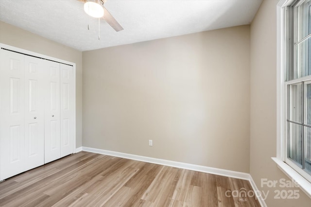 1409 Kensington Rd Unit B-8, Hendersonville, NC 28791 - unfurnished bedroom featuring light wood-type flooring, a closet, and ceiling fan