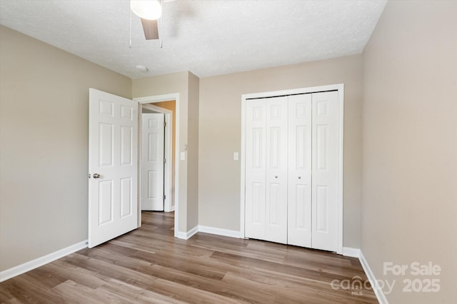 1409 Kensington Rd Unit B-8, Hendersonville, NC 28791 - unfurnished bedroom featuring wood finished floors, a closet, ceiling fan, and a textured ceiling