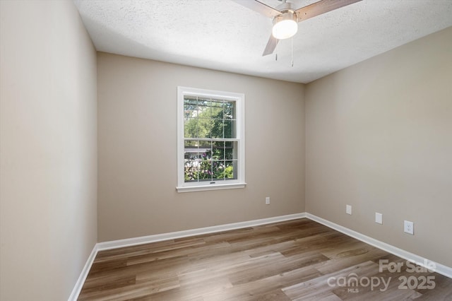 1409 Kensington Rd Unit B-8, Hendersonville, NC 28791 - empty room with wood finished floors, ceiling fan, and a textured ceiling