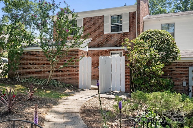1409 Kensington Rd Unit B-8, Hendersonville, NC 28791 - view of front of home featuring brick siding and a chimney