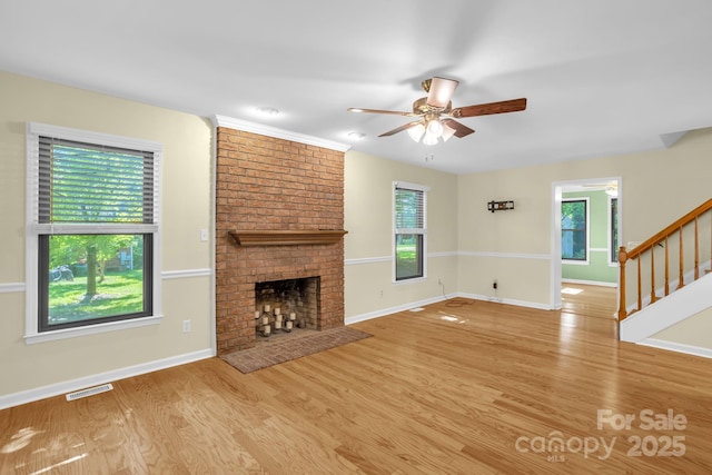 106 Birmingham Pl, Salisbury, NC 28146 - unfurnished living room with a ceiling fan, light wood-type flooring, stairs, and a brick fireplace