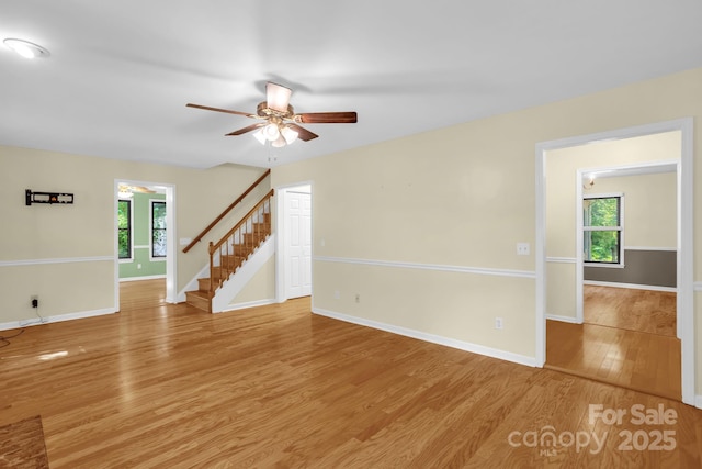 106 Birmingham Pl, Salisbury, NC 28146 - unfurnished room featuring stairs, light wood-style floors, plenty of natural light, and ceiling fan