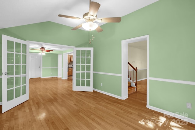 106 Birmingham Pl, Salisbury, NC 28146 - spare room featuring french doors, ceiling fan, lofted ceiling, light wood-type flooring, and stairs