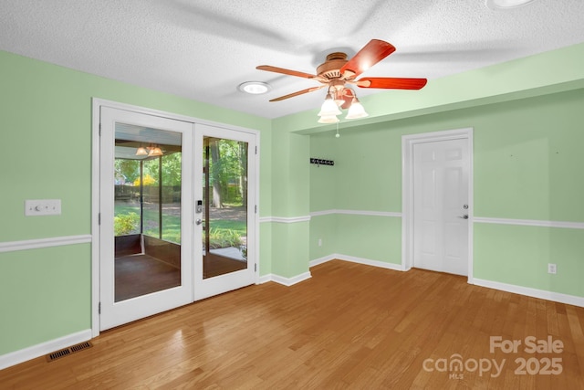 106 Birmingham Pl, Salisbury, NC 28146 - spare room with french doors, wood finished floors, ceiling fan, and a textured ceiling