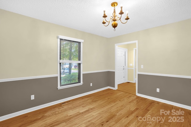 106 Birmingham Pl, Salisbury, NC 28146 - spare room featuring a chandelier, light wood-style flooring, and a textured ceiling