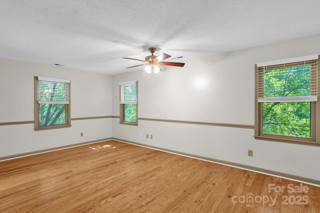 106 Birmingham Pl, Salisbury, NC 28146 - unfurnished room with healthy amount of natural light, wood finished floors, ceiling fan, and a textured ceiling