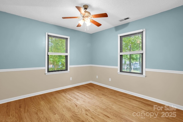 106 Birmingham Pl, Salisbury, NC 28146 - unfurnished room featuring healthy amount of natural light, wood finished floors, a ceiling fan, and a textured ceiling
