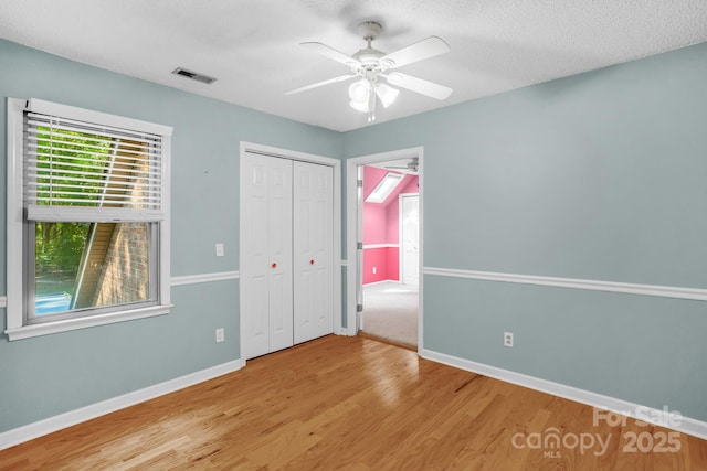 106 Birmingham Pl, Salisbury, NC 28146 - unfurnished bedroom featuring wood finished floors, a closet, and a ceiling fan