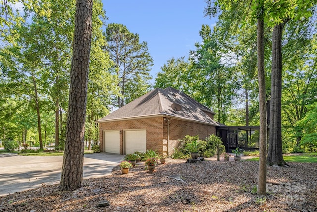 106 Birmingham Pl, Salisbury, NC 28146 - view of home's exterior with brick siding, an attached garage, driveway, and a shingled roof