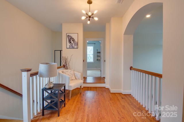 812 Cedar St, Mcadenville, NC 28101 - hallway featuring arched walkways, light wood-type flooring, and a chandelier