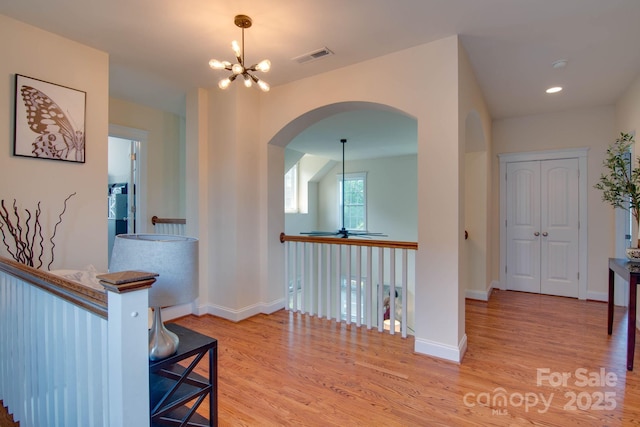 812 Cedar St, Mcadenville, NC 28101 - hallway featuring arched walkways, wood finished floors, and a chandelier