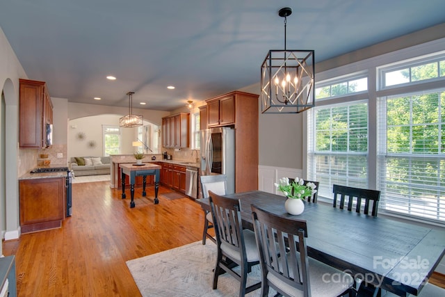 812 Cedar St, Mcadenville, NC 28101 - dining room with a chandelier, arched walkways, light wood-style flooring, recessed lighting, and wainscoting