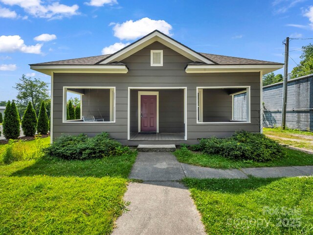 118 Railroad Ave, Brevard, NC 28712 - bungalow-style house featuring a front lawn, a porch, and roof with shingles