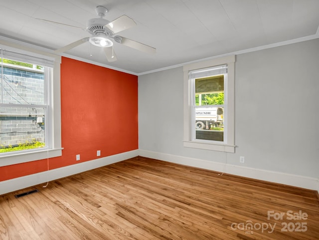 118 Railroad Ave, Brevard, NC 28712 - empty room with plenty of natural light, wood finished floors, ornamental molding, and a ceiling fan
