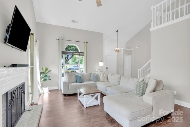 5901 Creft Cir, Indian Trail, NC 28079 - living room featuring high vaulted ceiling, a fireplace, wood finished floors, and a ceiling fan