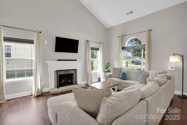 5901 Creft Cir, Indian Trail, NC 28079 - living room featuring high vaulted ceiling, a brick fireplace, and dark wood-type flooring