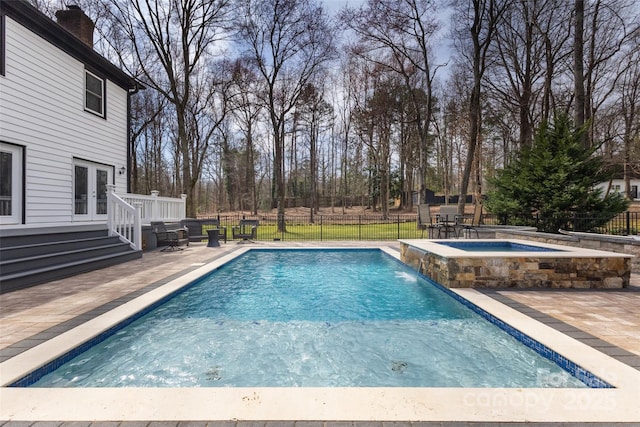 10700 Chestnut Hill Dr, Matthews, NC 28105 - view of swimming pool with french doors, a patio area, a pool with connected hot tub, and view of wooded area