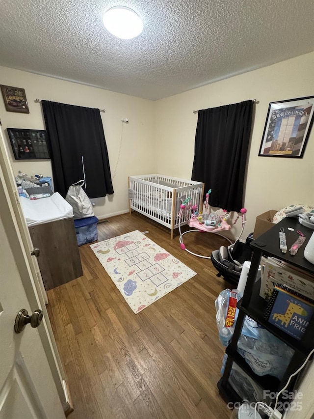 1045 Warren Pl NW, Lenoir, NC 28645 - bedroom featuring wood finished floors and a textured ceiling