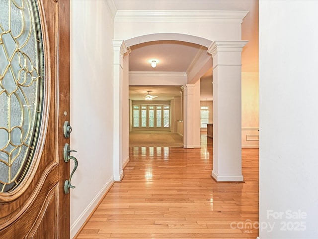 10638 Moss Mill Ln, Charlotte, NC 28277 - foyer entrance featuring crown molding, arched walkways, decorative columns, light wood finished floors, and a ceiling fan