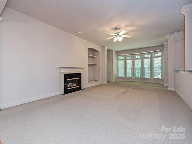 10638 Moss Mill Ln, Charlotte, NC 28277 - unfurnished living room featuring a ceiling fan, built in shelves, a fireplace with flush hearth, and light carpet