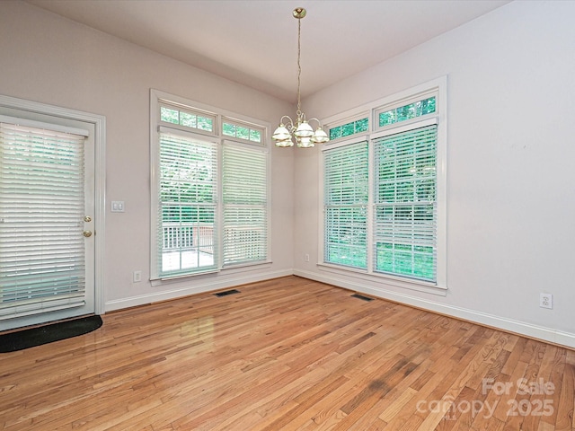 10638 Moss Mill Ln, Charlotte, NC 28277 - unfurnished dining area with a chandelier and light wood-style floors