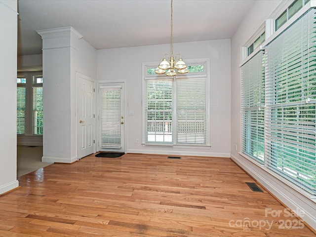 10638 Moss Mill Ln, Charlotte, NC 28277 - unfurnished dining area with a chandelier and light wood finished floors