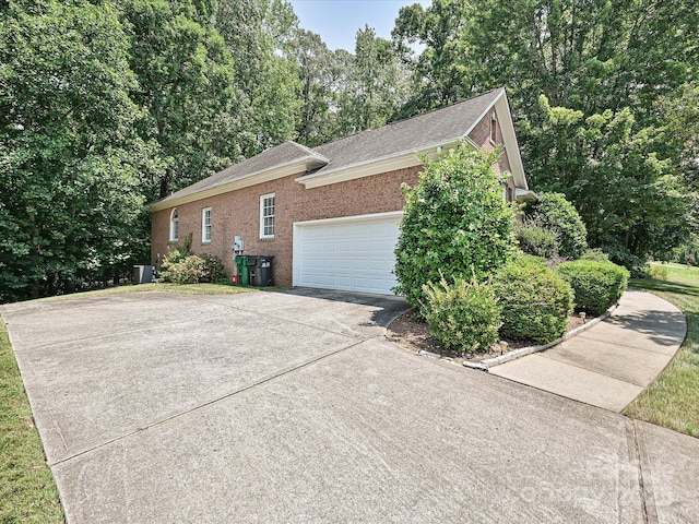 10638 Moss Mill Ln, Charlotte, NC 28277 - view of home's exterior featuring concrete driveway, brick siding, a garage, and a shingled roof