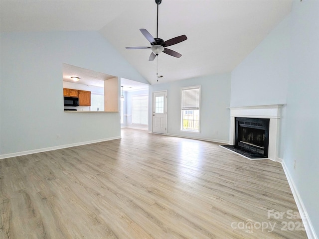 4002 Beaverbrook Dr, Indian Trail, NC 28079 - unfurnished living room featuring a ceiling fan, light wood-style floors, a fireplace, and high vaulted ceiling