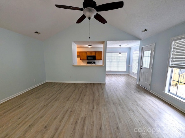 4002 Beaverbrook Dr, Indian Trail, NC 28079 - unfurnished living room featuring vaulted ceiling, light wood-style flooring, and ceiling fan
