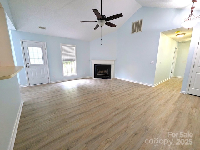 4002 Beaverbrook Dr, Indian Trail, NC 28079 - unfurnished living room featuring a ceiling fan, light wood-style flooring, a fireplace, and high vaulted ceiling