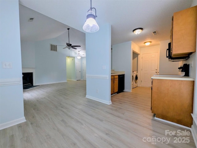 4002 Beaverbrook Dr, Indian Trail, NC 28079 - kitchen featuring washer / dryer, ceiling fan, light wood finished floors, brown cabinets, and lofted ceiling
