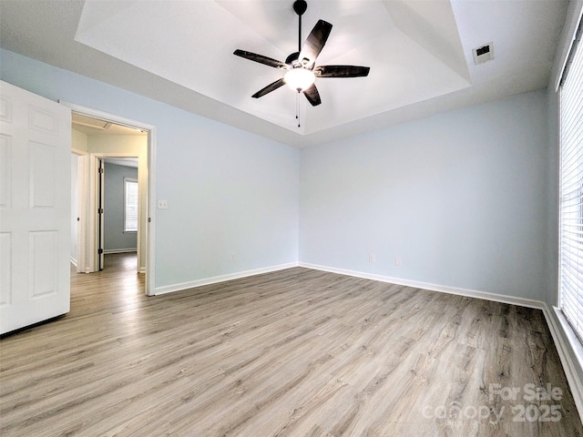 4002 Beaverbrook Dr, Indian Trail, NC 28079 - spare room with a tray ceiling, light wood-type flooring, and a ceiling fan