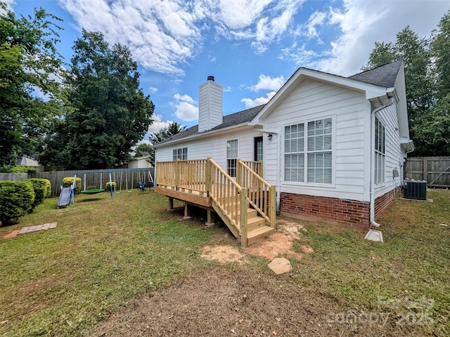 4002 Beaverbrook Dr, Indian Trail, NC 28079 - back of house featuring a fenced backyard, a wooden deck, a chimney, and roof with shingles