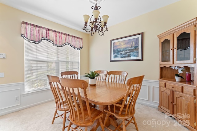 5630 Cambridge Bay Dr, Charlotte, NC 28269 - dining room featuring light carpet, wainscoting, a chandelier, and a decorative wall