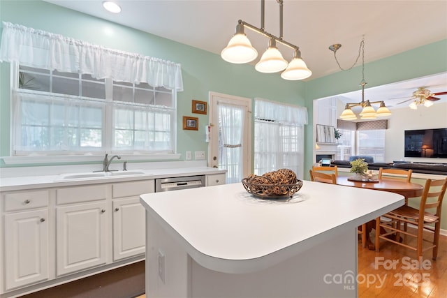 5630 Cambridge Bay Dr, Charlotte, NC 28269 - kitchen with white cabinetry, pendant lighting, ceiling fan, open floor plan, and a center island